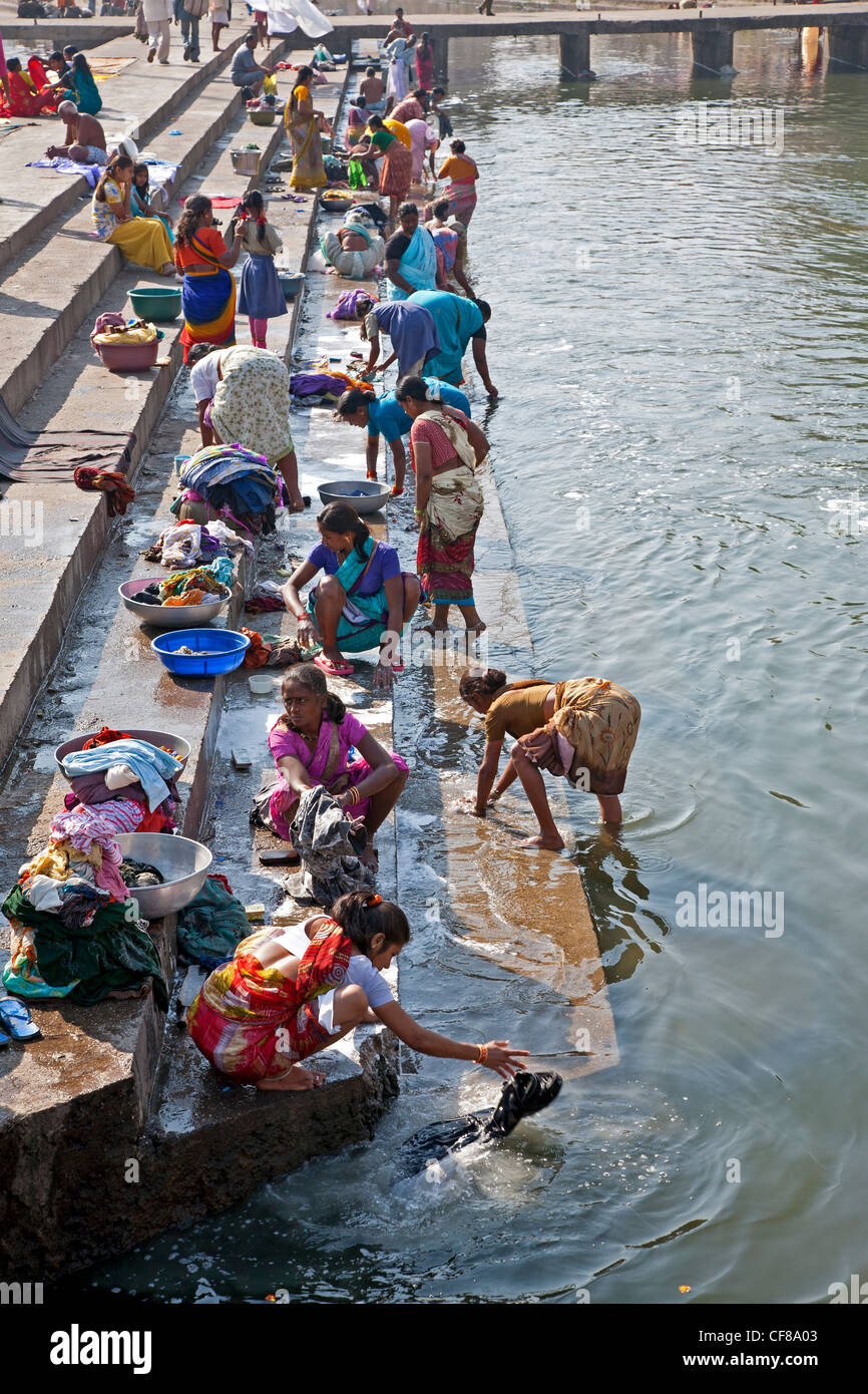 Indian women doing the laundry. Godavari river. Nasik. India Stock
