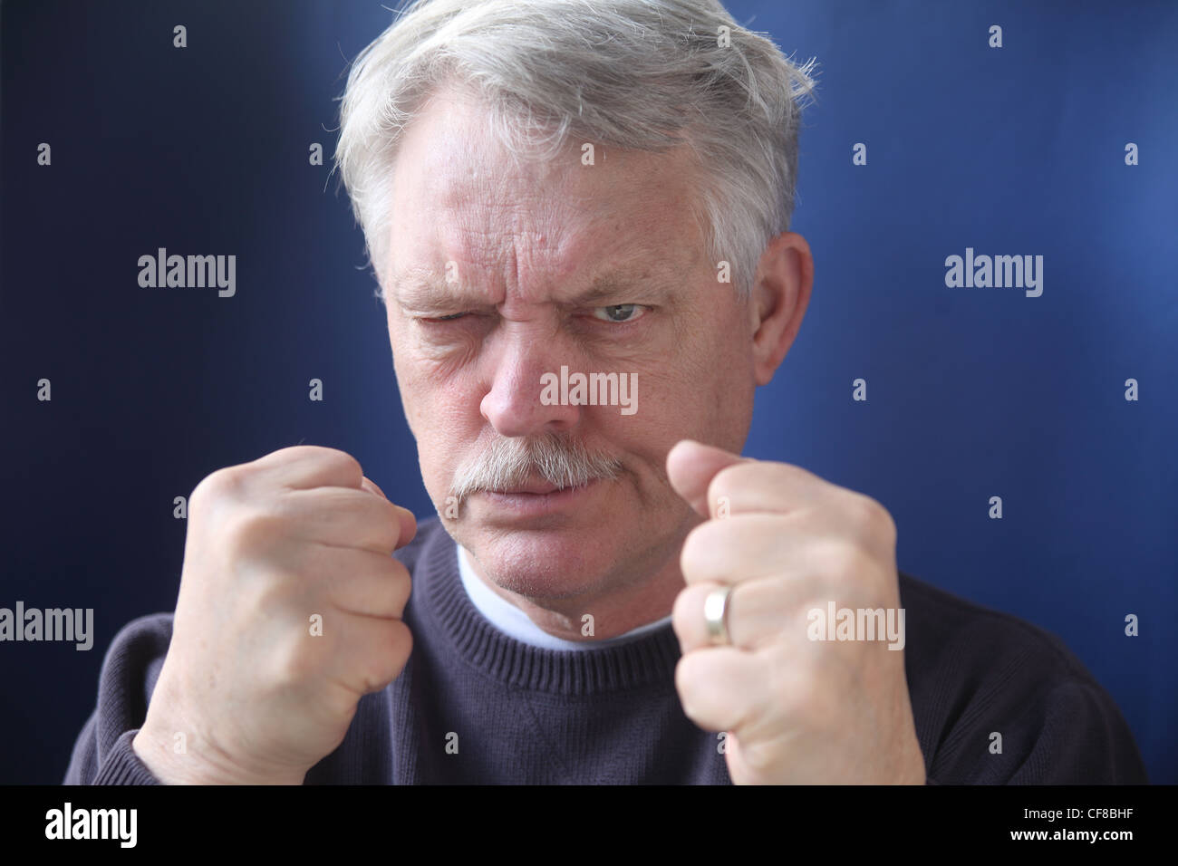 belligerent older man is angry and ready for a fight Stock Photo