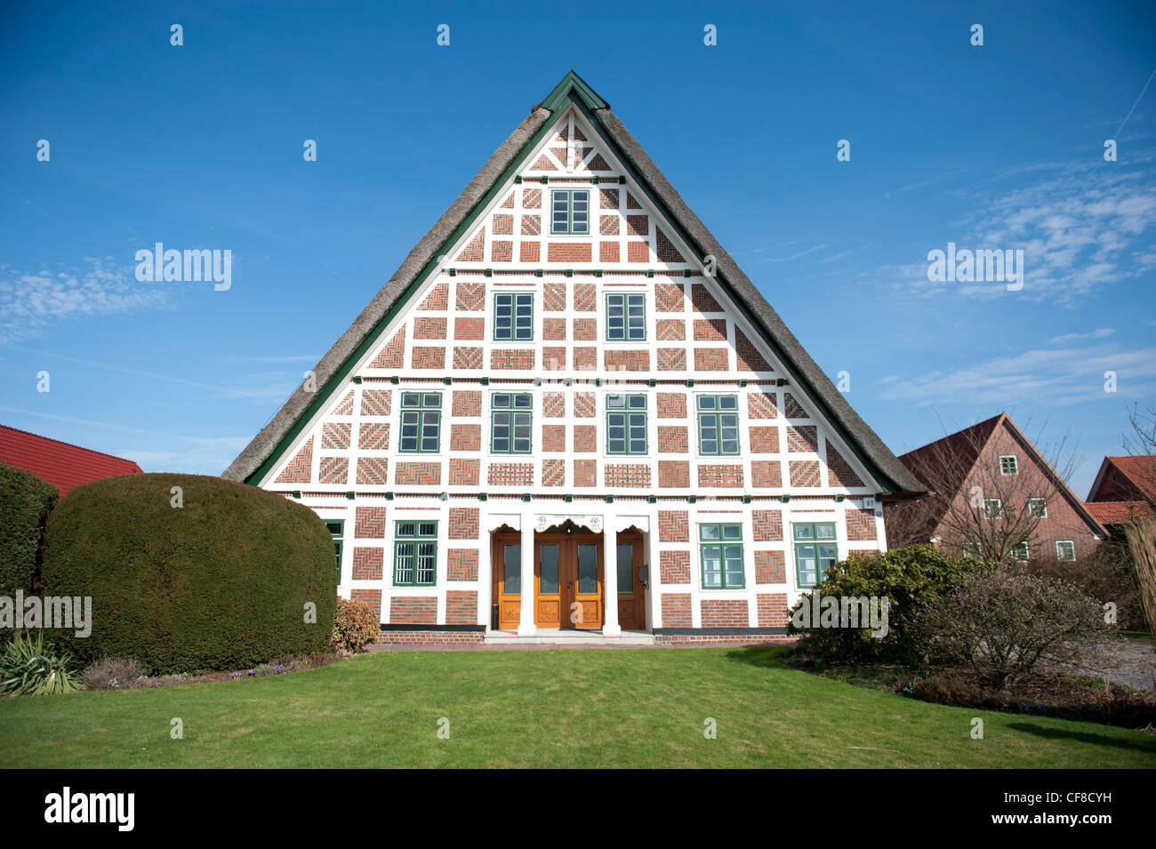Red brick, white wood: typical half-timbered farmhouse at Jork in the fruit-growing Altes Land region in Lower Saxony, Germany Stock Photo