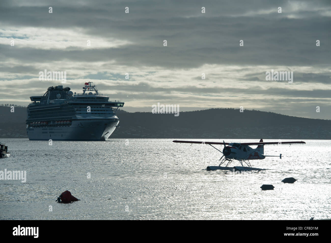 The Diamond Princess Cruise Ship and a De Havilland Beaver Silhouette in Early Morning Light from Franklin Wharf in Hobart, Tas Stock Photo