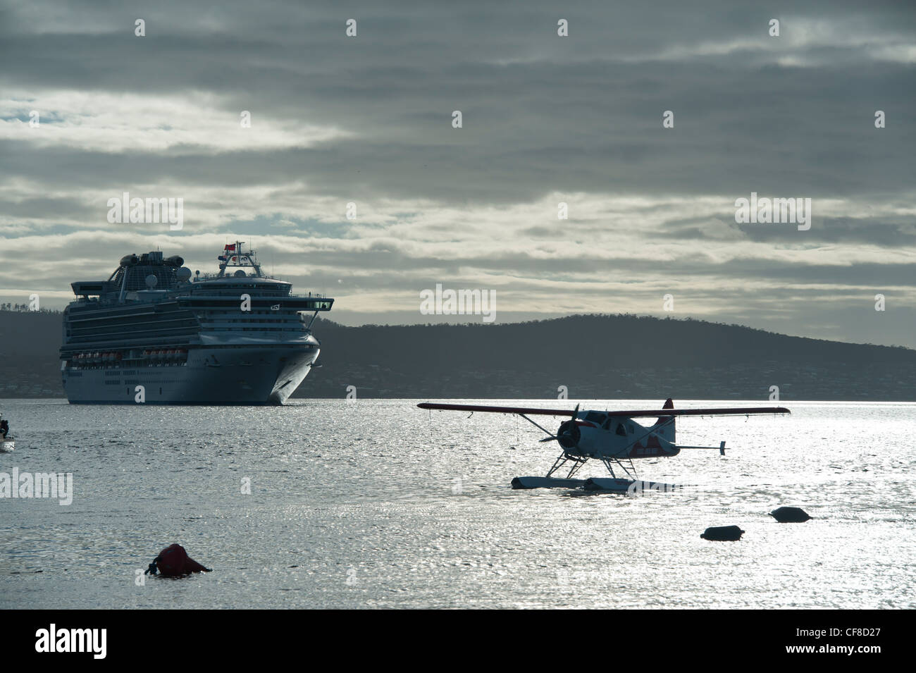 The Diamond Princess Cruise Ship and a De Havilland Beaver Silhouette in Early Morning Light from Franklin Wharf in Hobart, Tasm Stock Photo