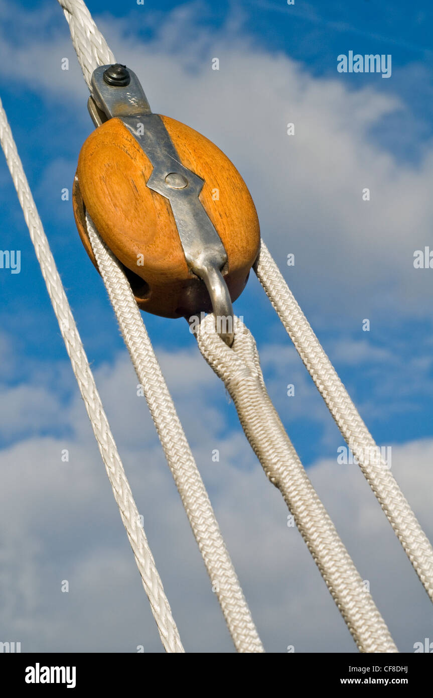 A wooden pulley and ropes on a sailboat Stock Photo