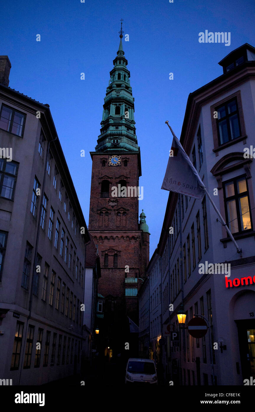 A view of the spire of Nicolaj Church Belltower, Copenhagen, Denmark at night Stock Photo