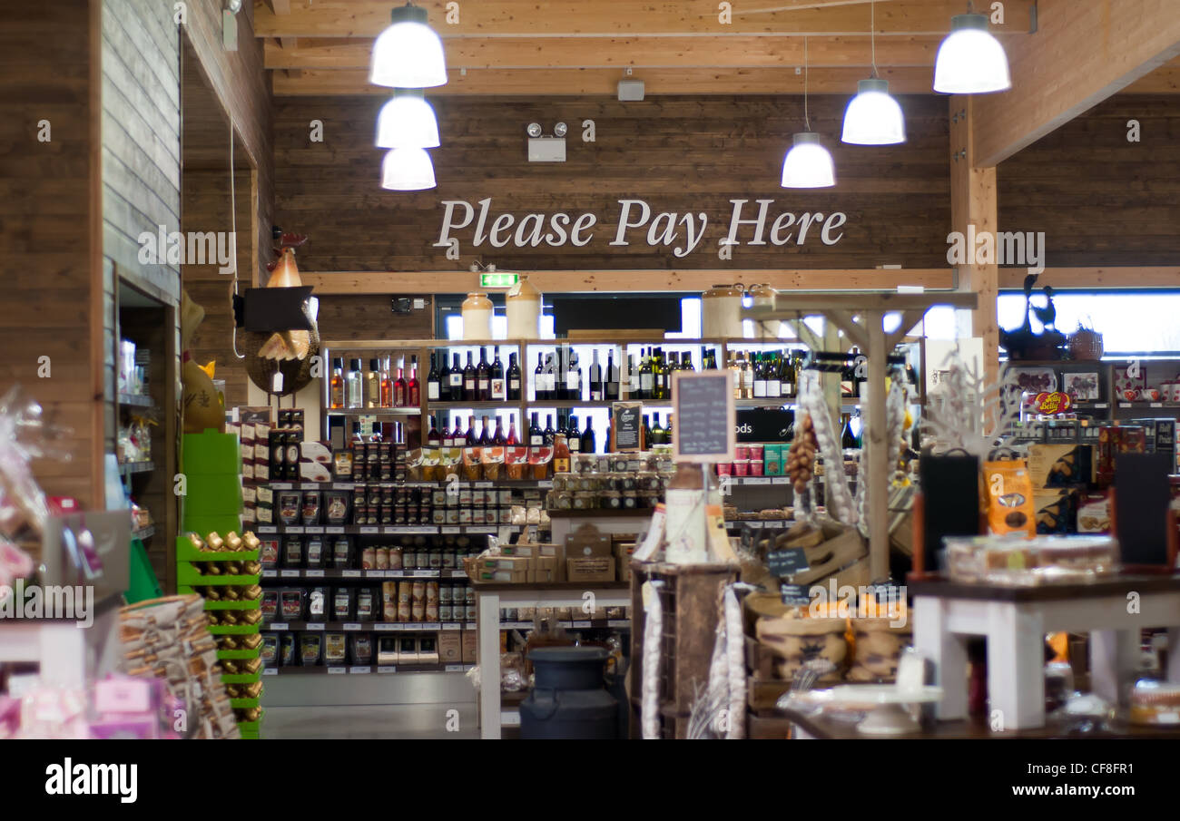 Please Pay Here area in a Dobbies garden center - delicatessen shop Stock Photo