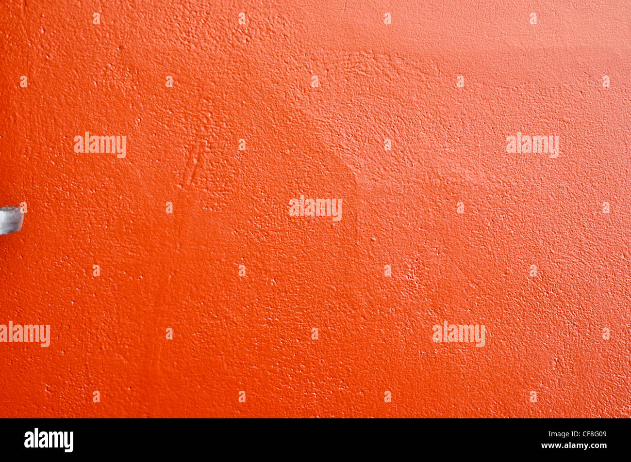 Close-up of a bright red wall painted with shiny paint Stock Photo