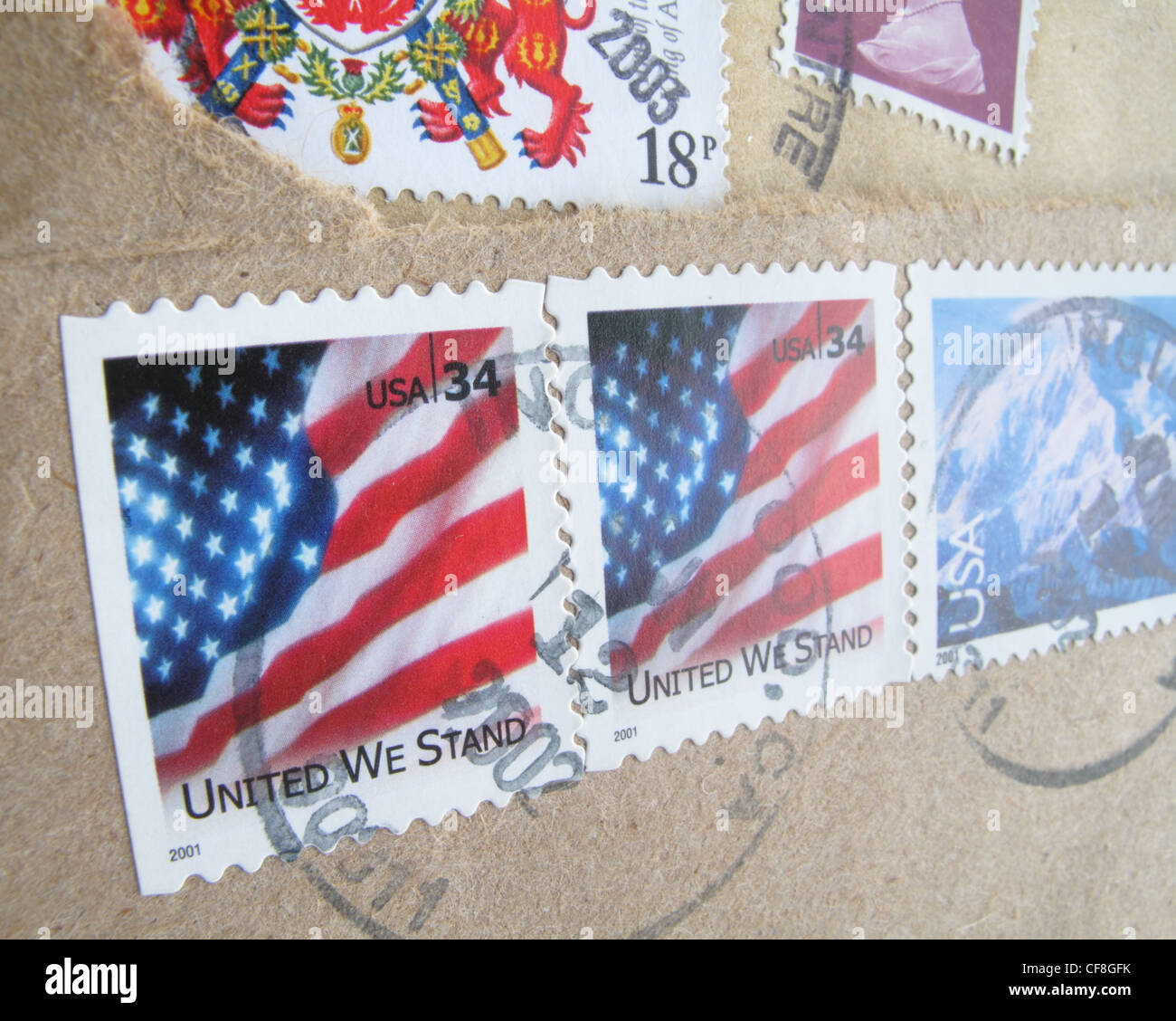 Franked American stamps showing the stars and stripes flag with the motto - In God we trust. Stock Photo