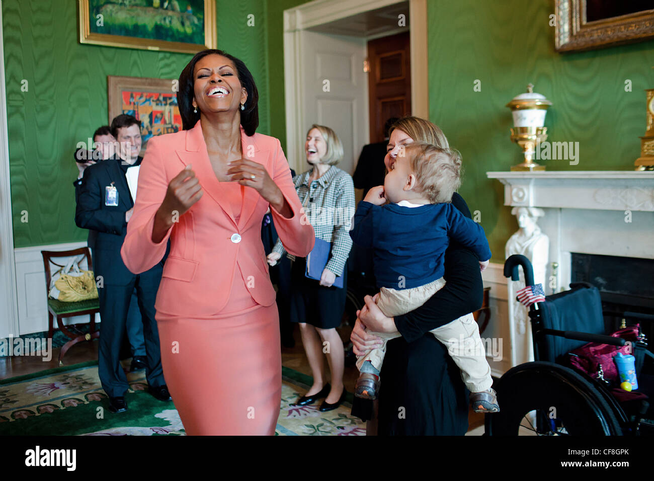 First Lady Michelle Obama laughs while visiting with Brianna Mast, wife
