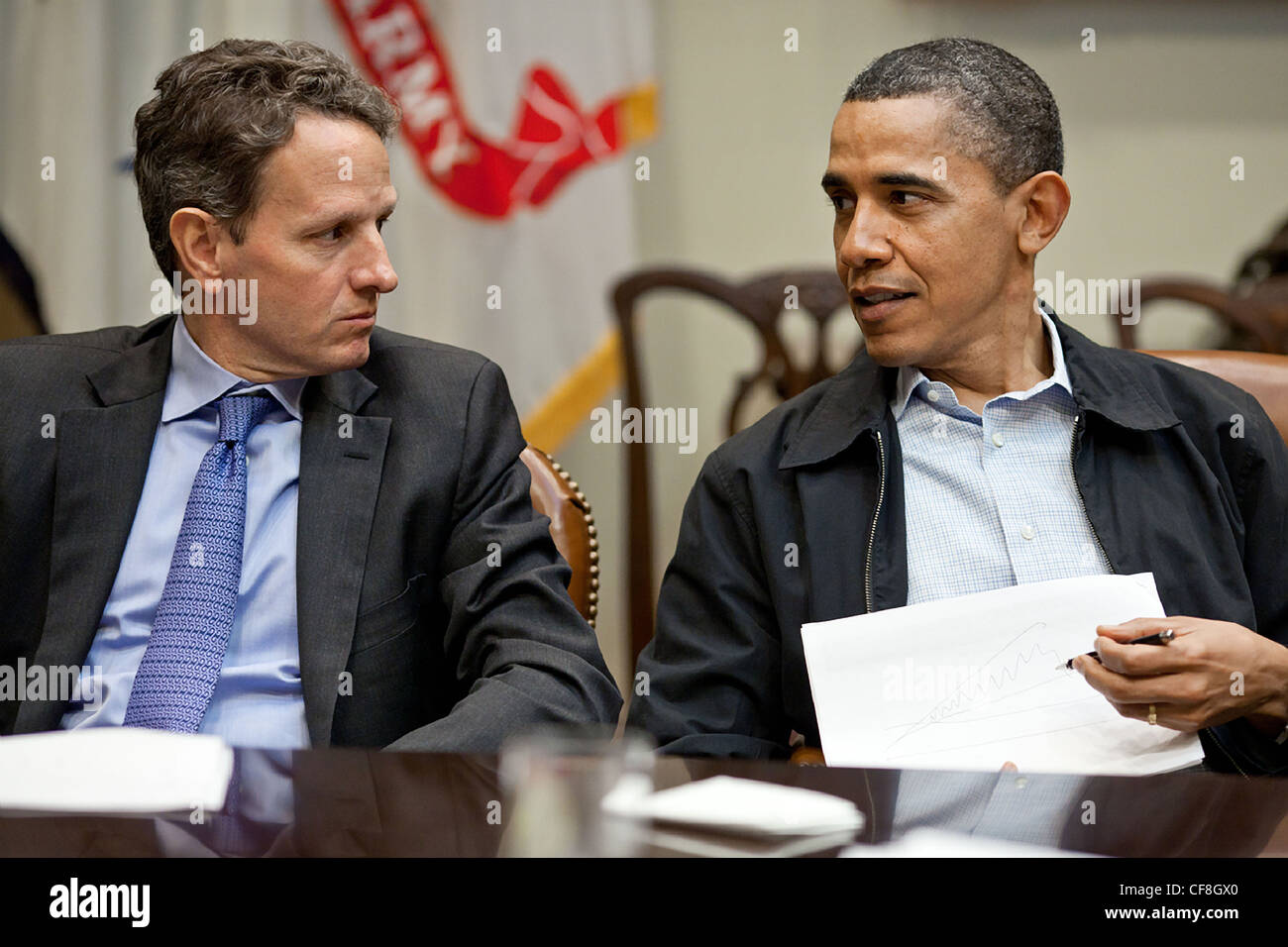 President Barack Obama talks with Treasury Secretary Timothy Geithner during fiscal policy meeting in the Roosevelt Room of the White House April 9, 2011 in Washington, DC. Stock Photo
