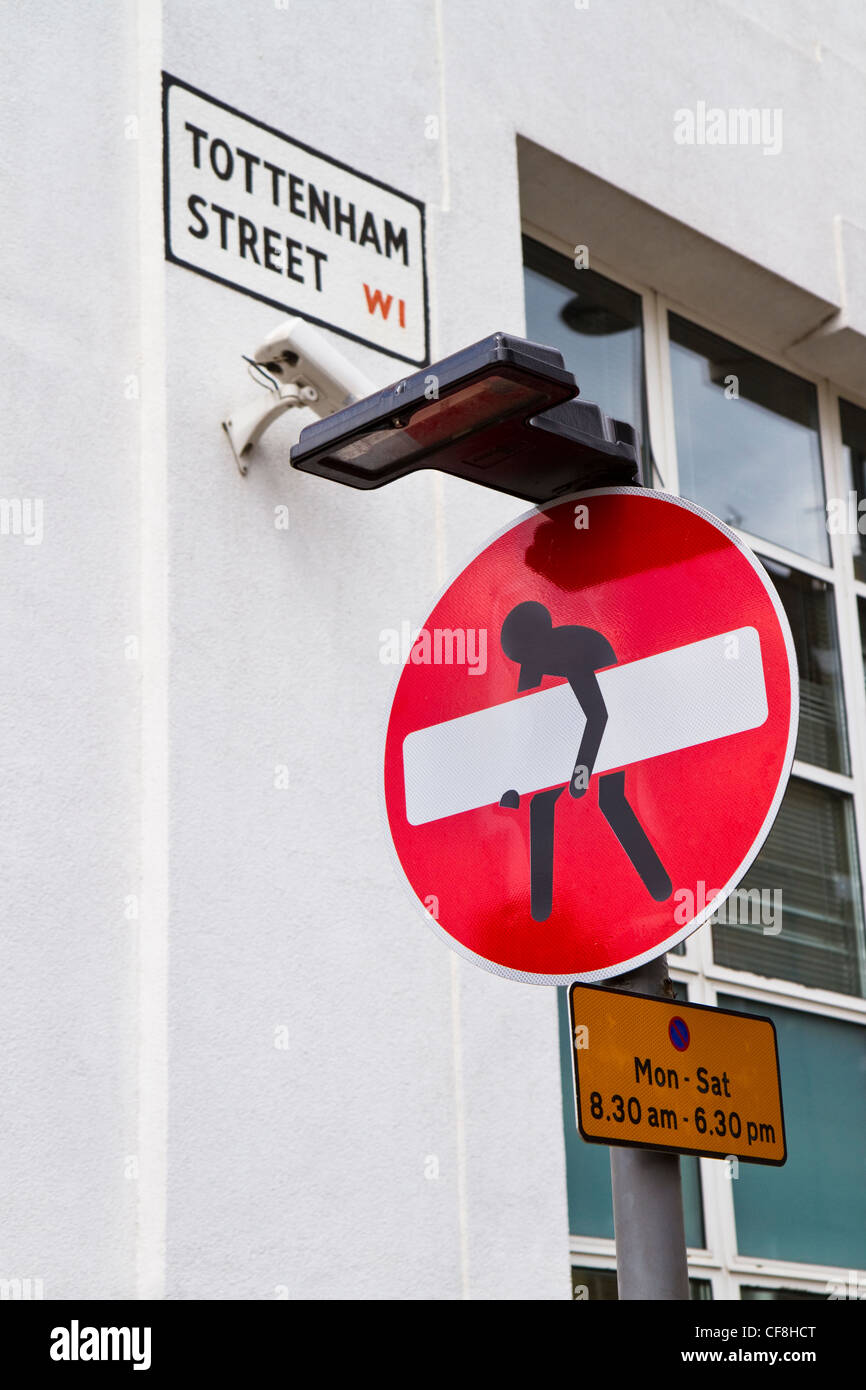 No Entry sign defaced to look like part of it is being stolen. The sign is in the west end of London, England. Stock Photo