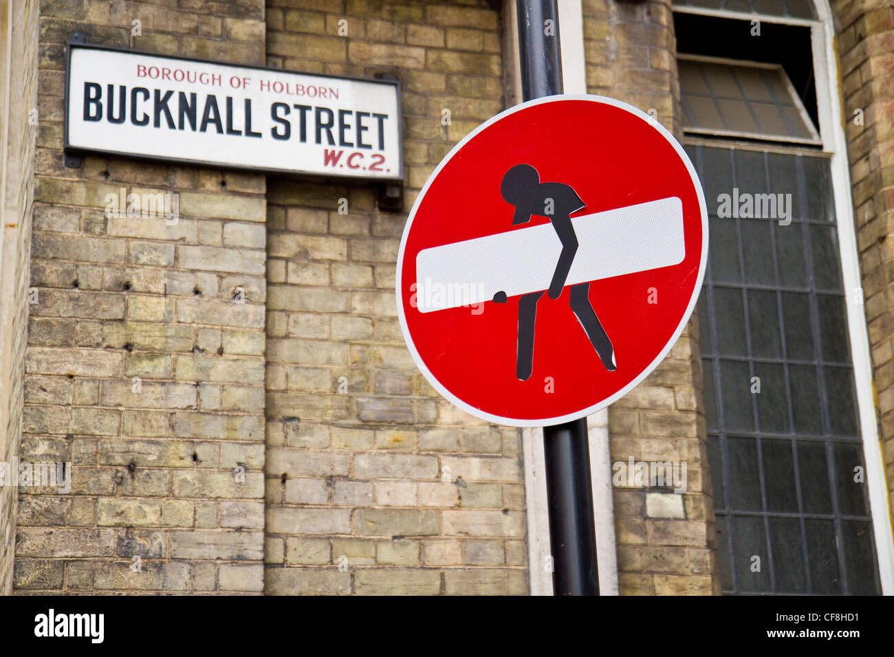 No Entry sign defaced to look like part of it is being stolen. The sign is in the west end of London, England. Stock Photo