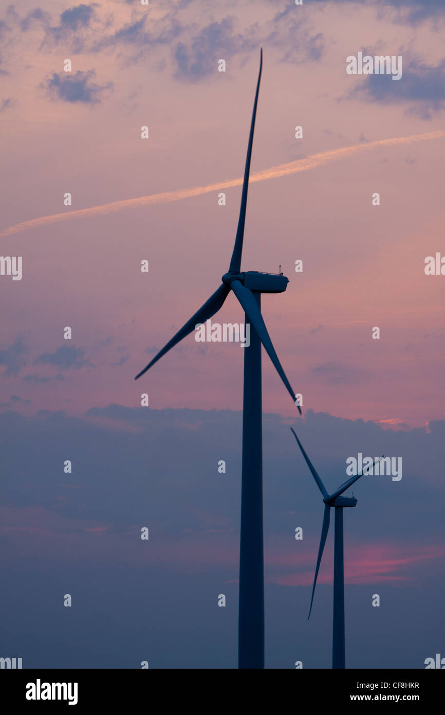 Wind turbines stand against a colorful sunset sky Stock Photo - Alamy