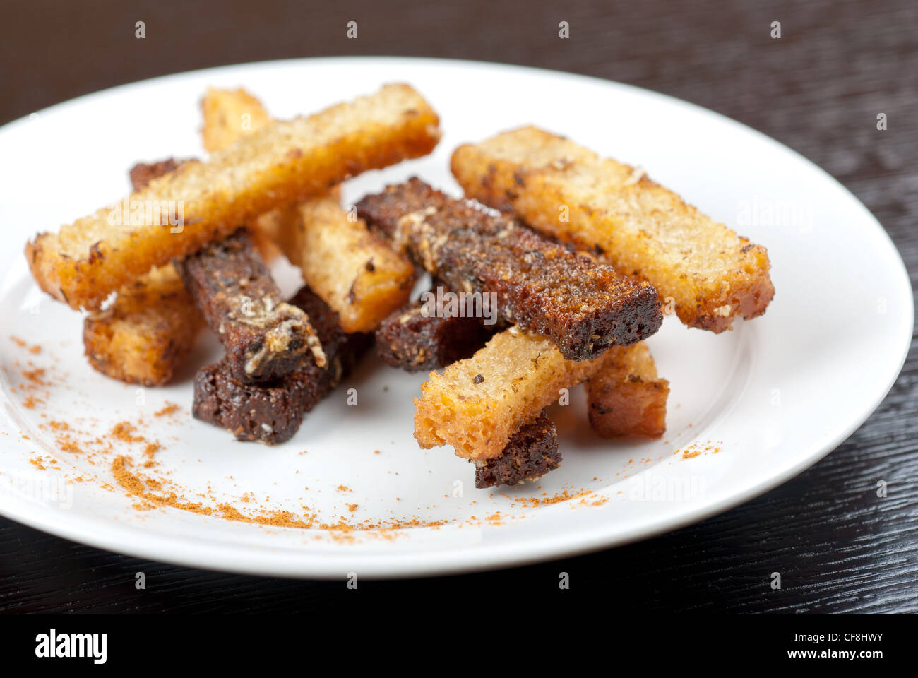 Chilli Rusk Rusk with garlic on a plate at wooden background Stock Photo - Alamy