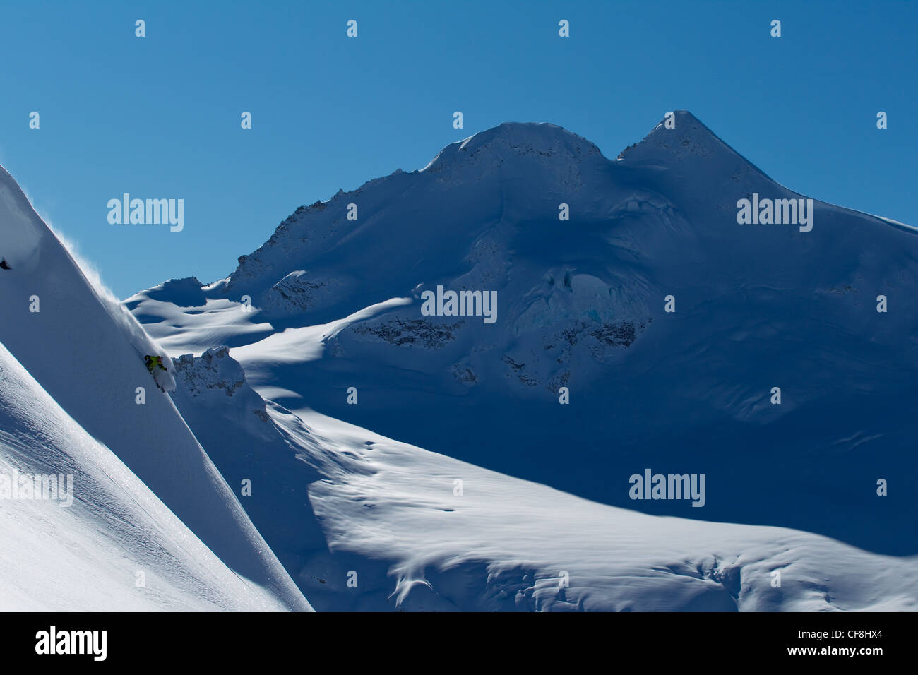 Backcountry skier skiing big powder lines in the Coast Mountains B.C. Canada Stock Photo