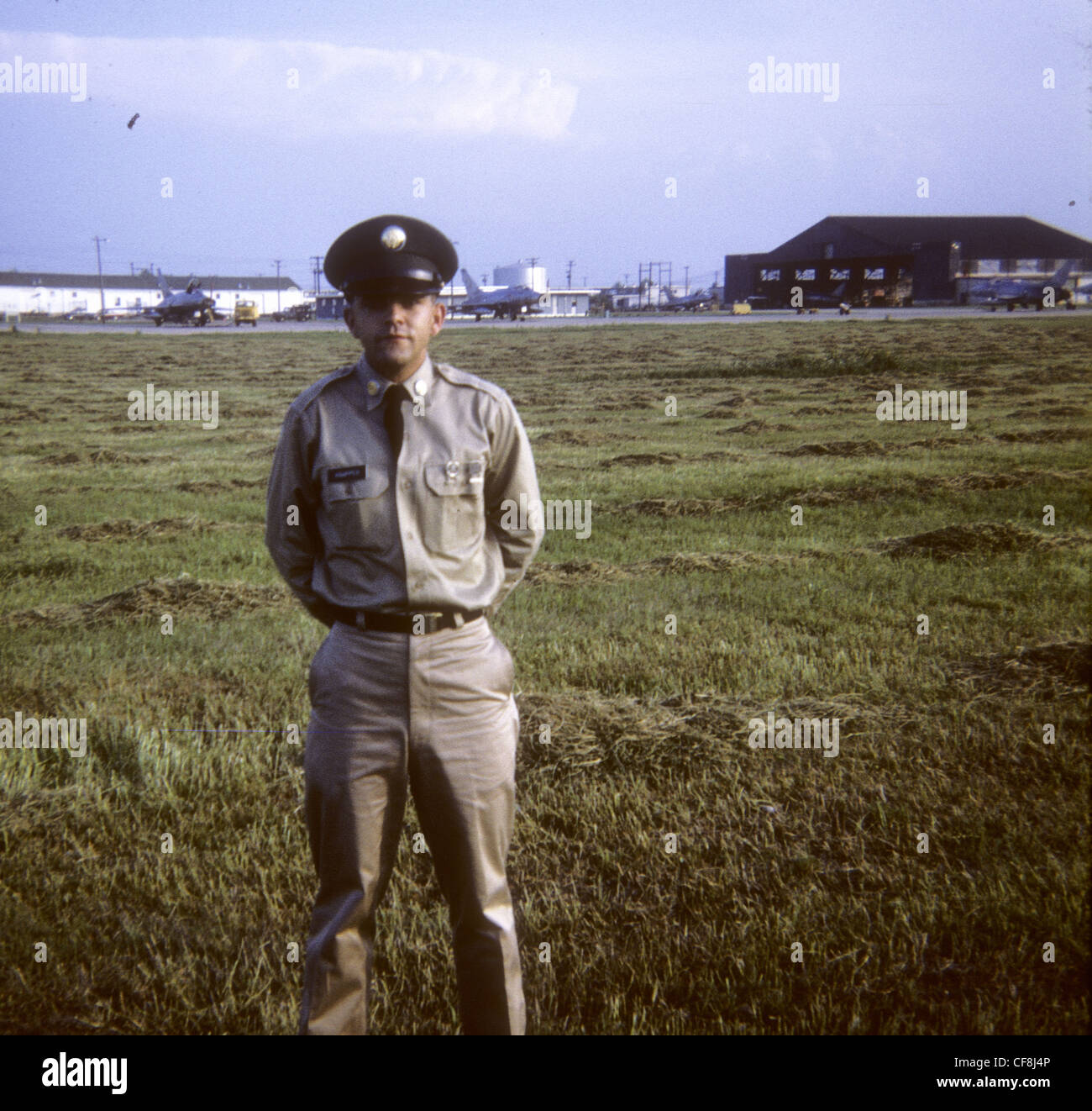 American solider in khaki uniform with jets parked in background 1/5th