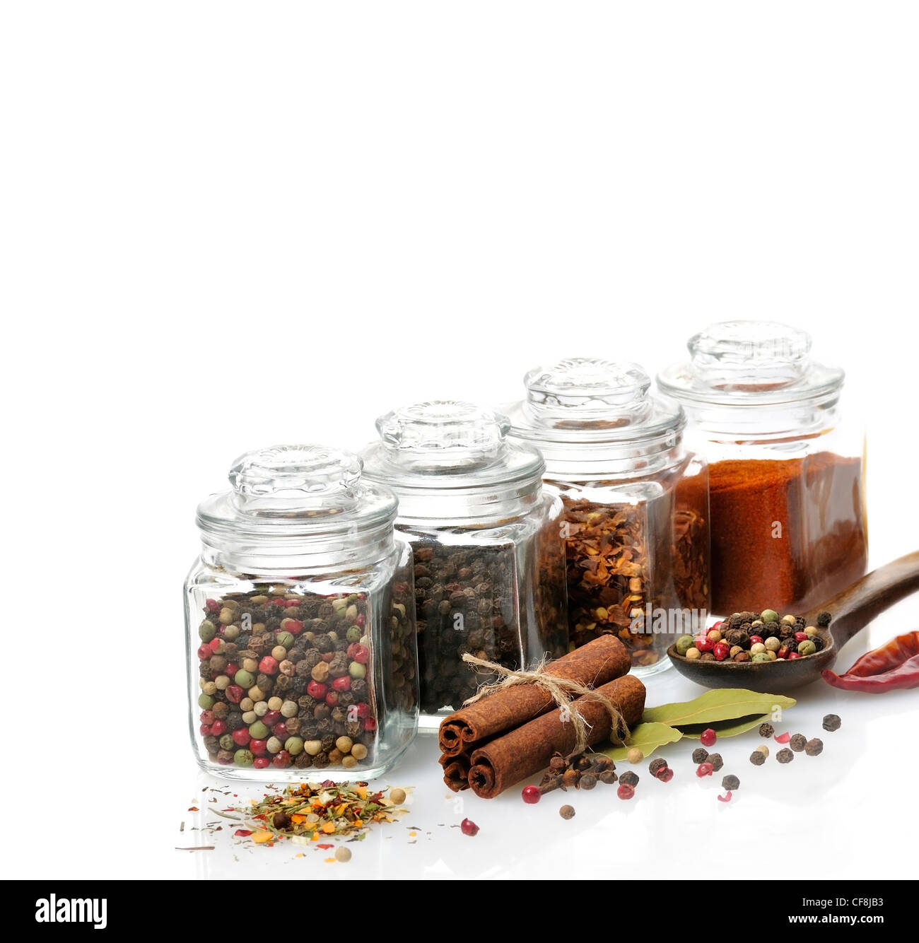 Premium Photo  Spices in glass jars on a pink background
