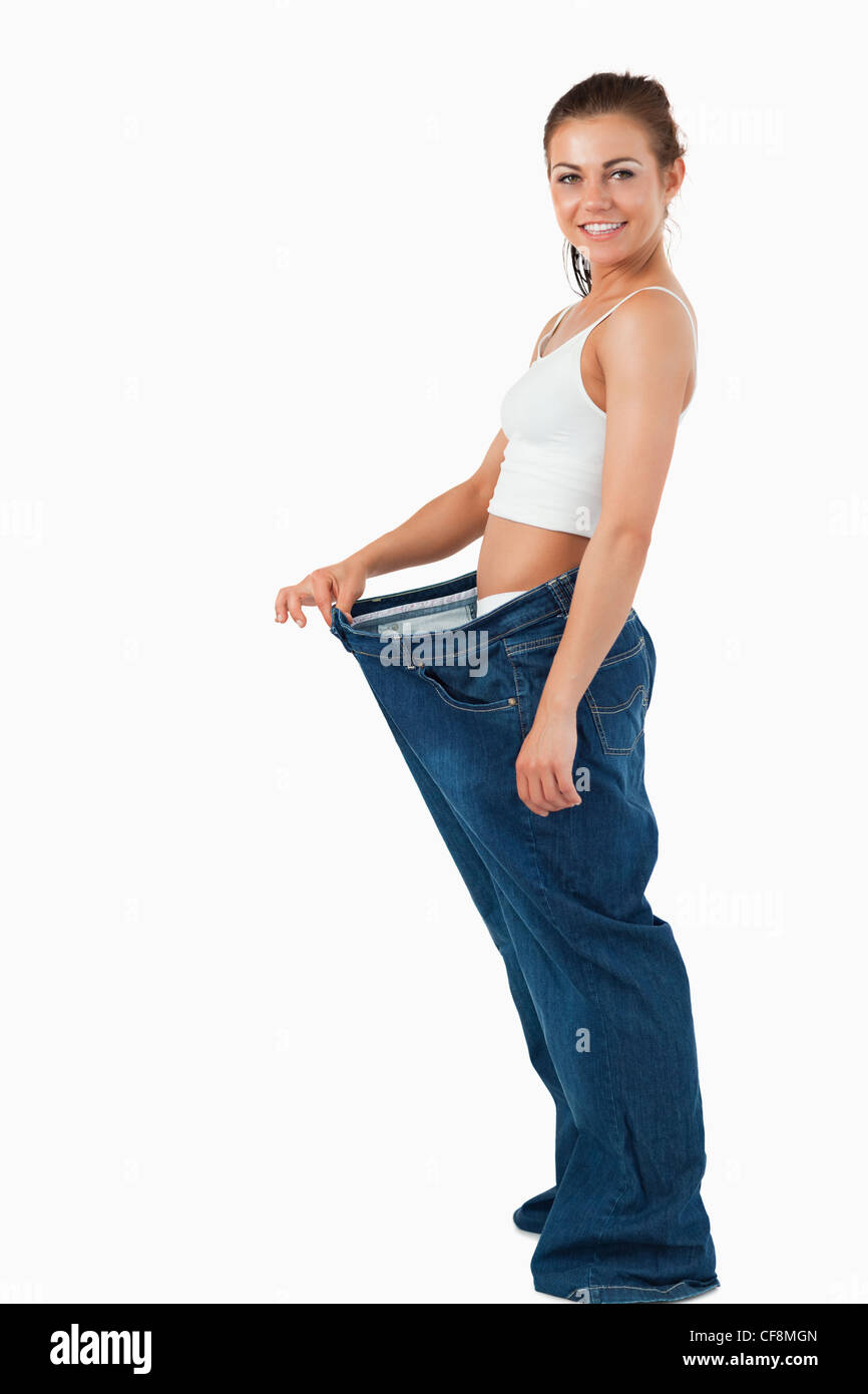 Portrait of a woman wearing too large pants Stock Photo - Alamy