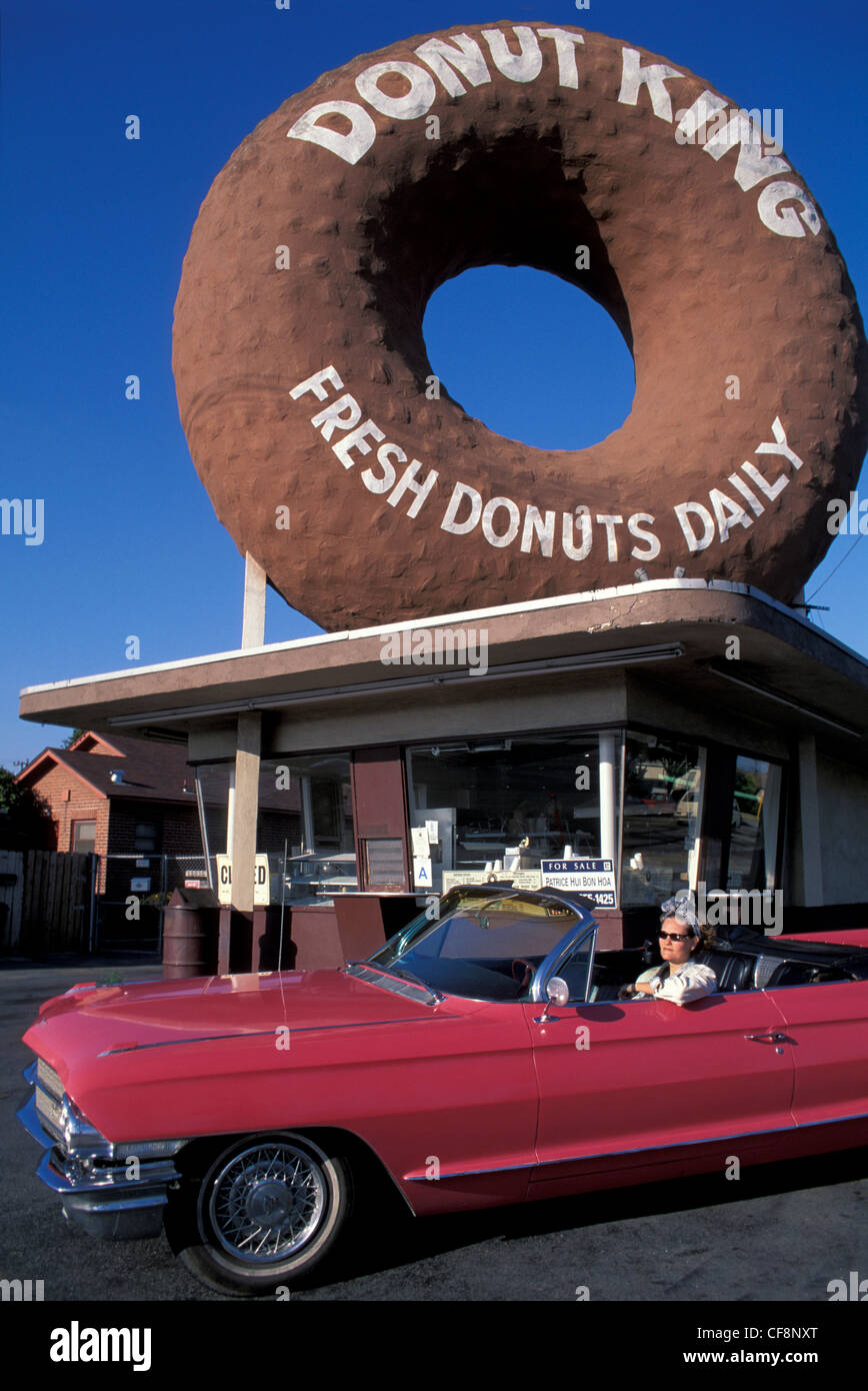 Donut King, Los Angeles, California, USA, United States, America, Giant donut, pink, Cadillac, 1962, woman, car, americana, LA Stock Photo