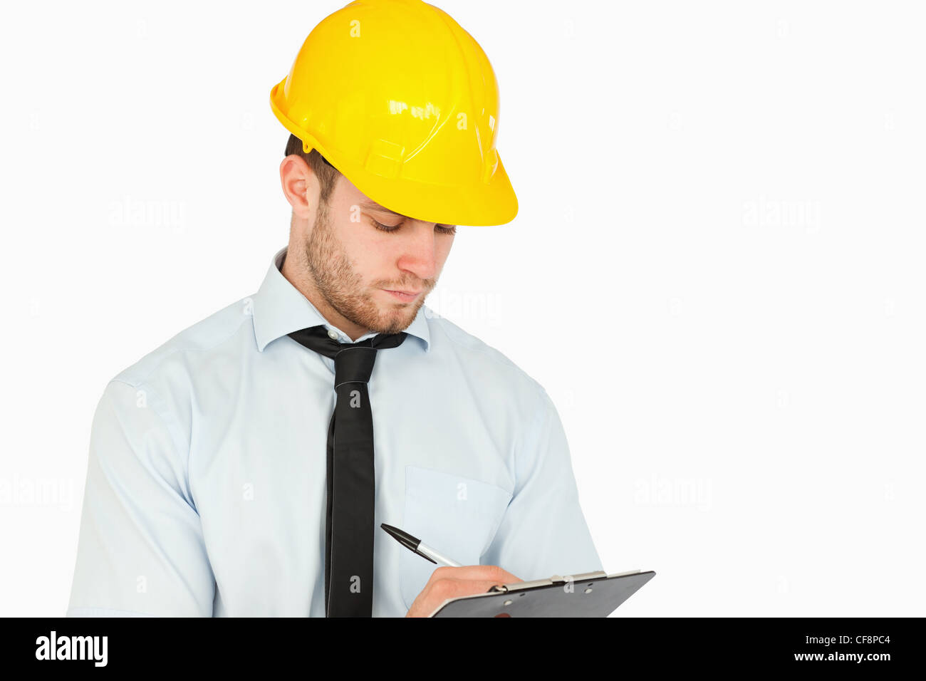 Young lead worker taking notes on his clipboard Stock Photo - Alamy