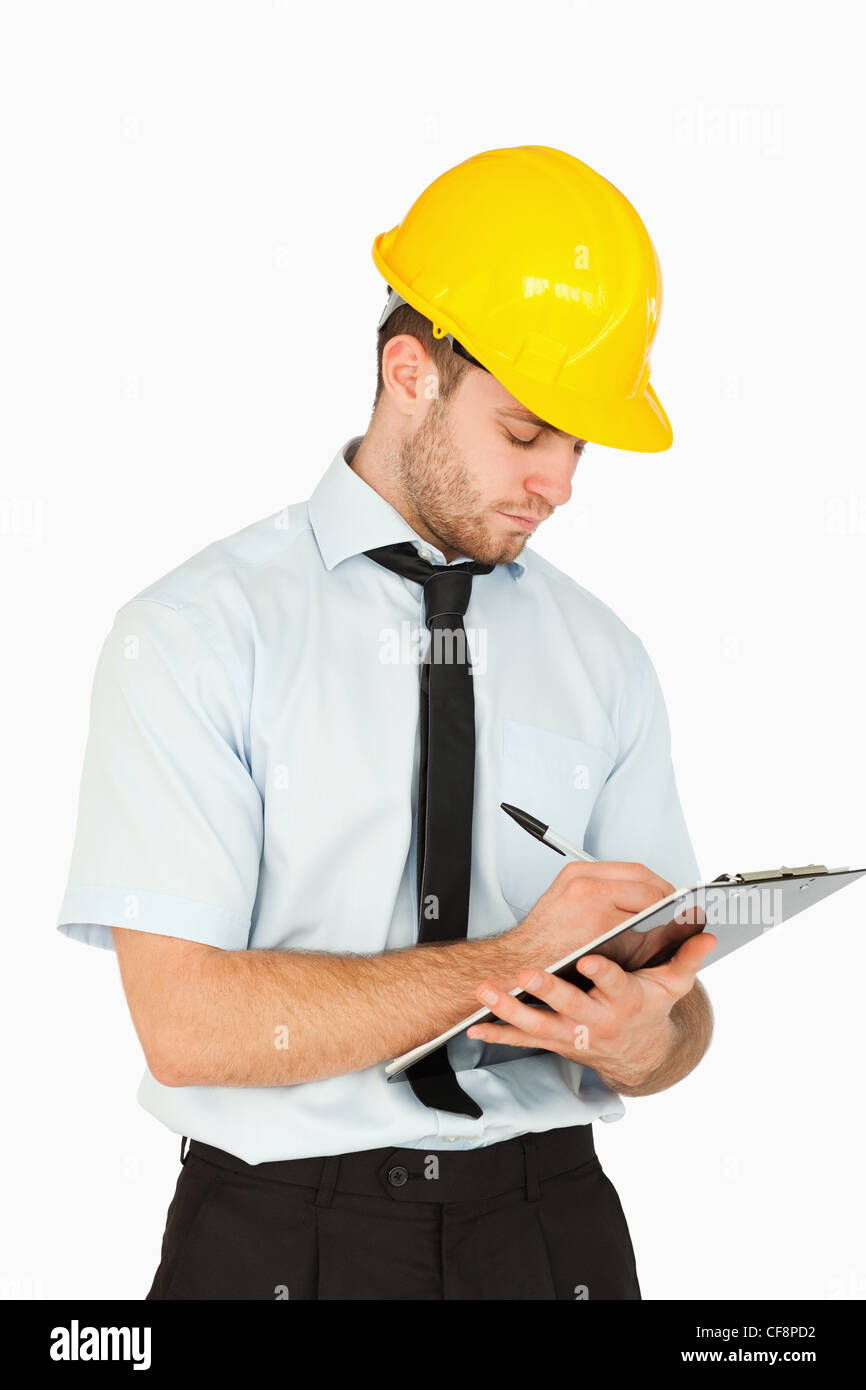 Young lead worker writing on his clipboard Stock Photo - Alamy