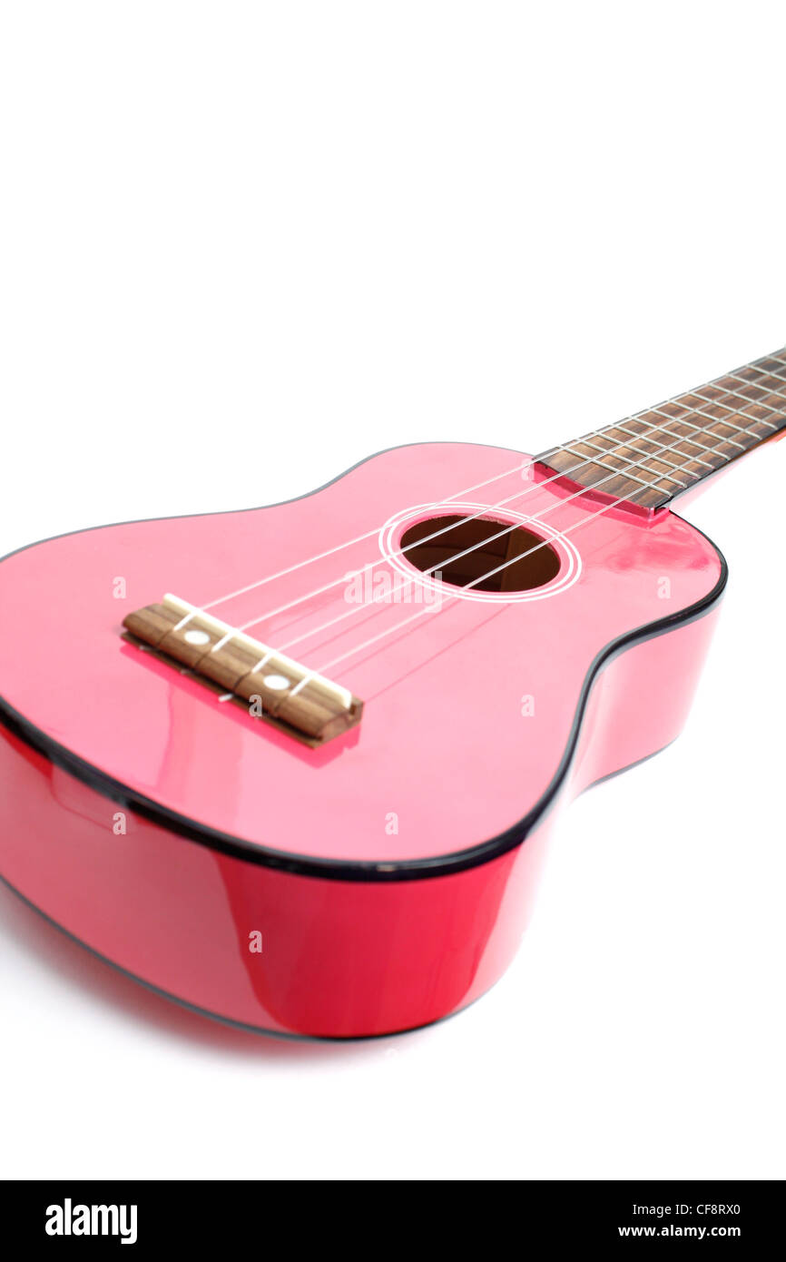 A small pink guitar isolated on white Stock Photo
