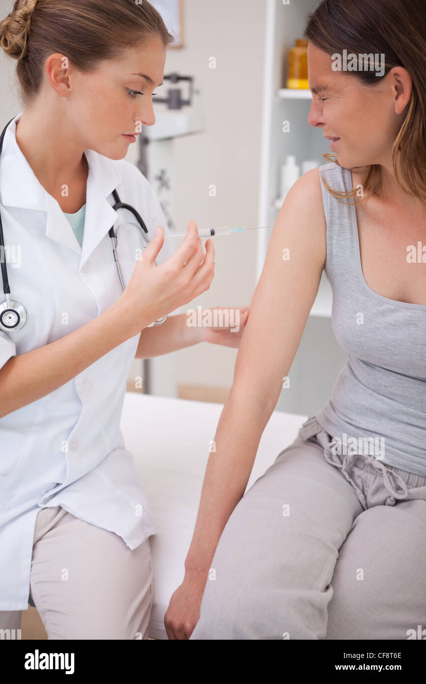 Patient receiving painful injection Stock Photo