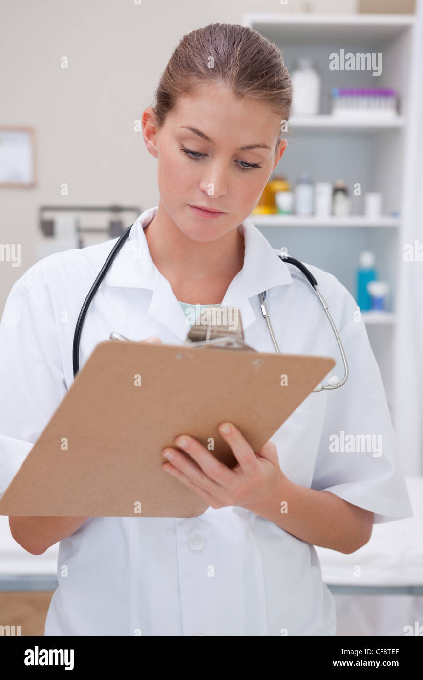 Doctor taking notes on clipboard Stock Photo - Alamy