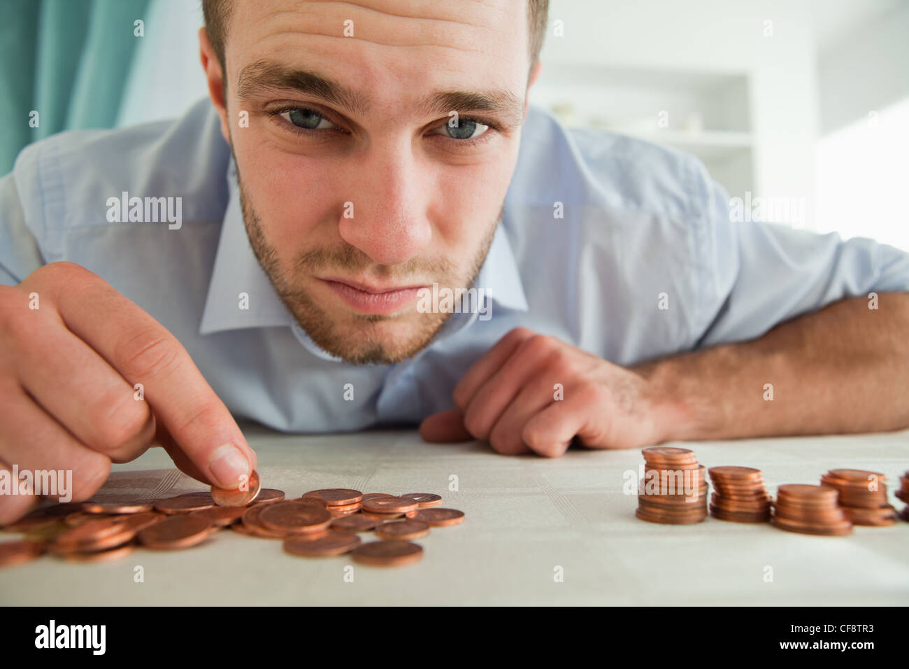 Desperate businessman counting his change Stock Photo - Alamy