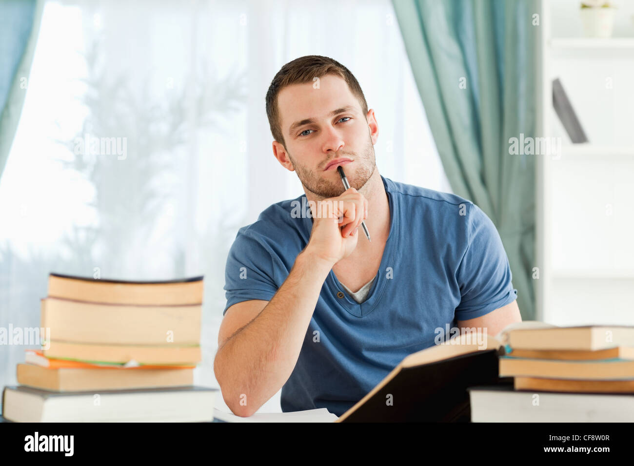 Student sitting at his desk doing his homework Stock Photo