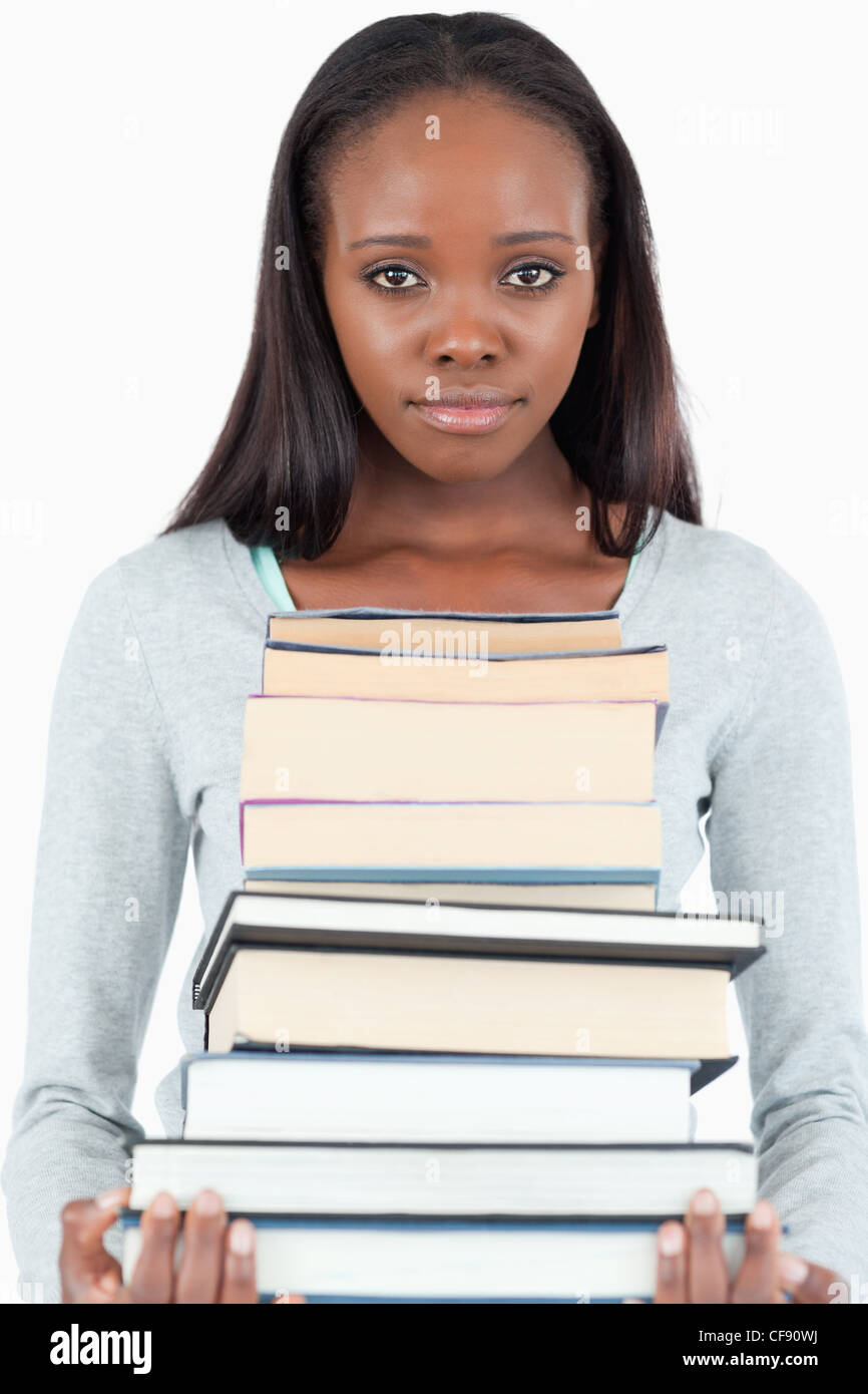 Sad looking young woman with pile of books Stock Photo - Alamy