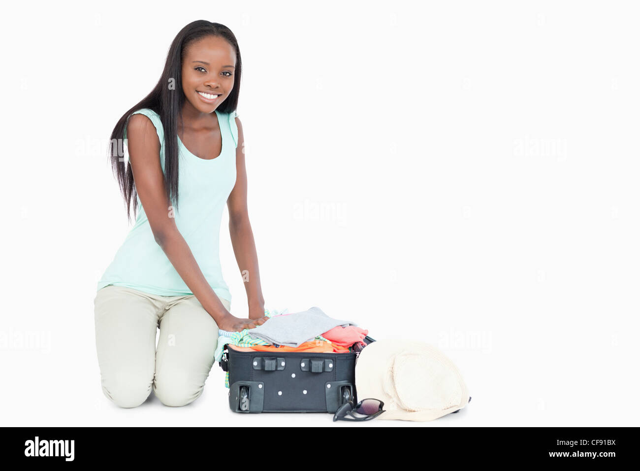 Young woman packing her suitcase Stock Photo - Alamy