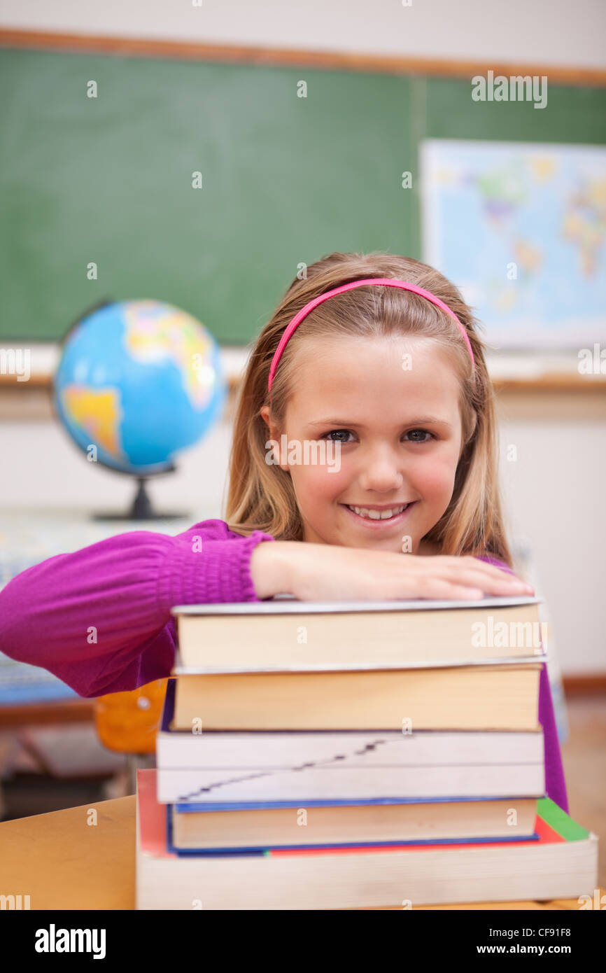 Portrait of schoolgirl posing with books Stock Photo - Alamy