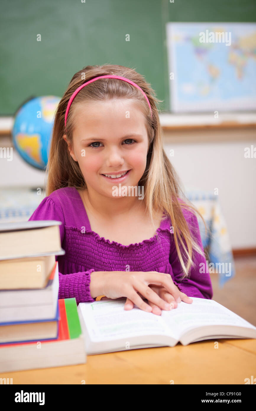 Portrait of young schoolgirl reading a book Stock Photo - Alamy