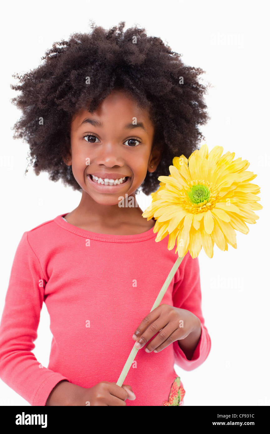 Portrait of a smiling girl holding a flower Stock Photo - Alamy