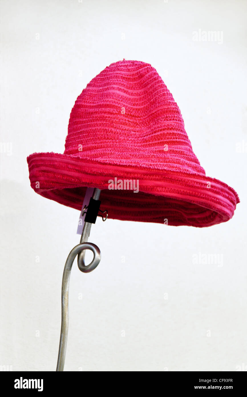 several red hats are waiting for buyers in front of a millinery Stock Photo
