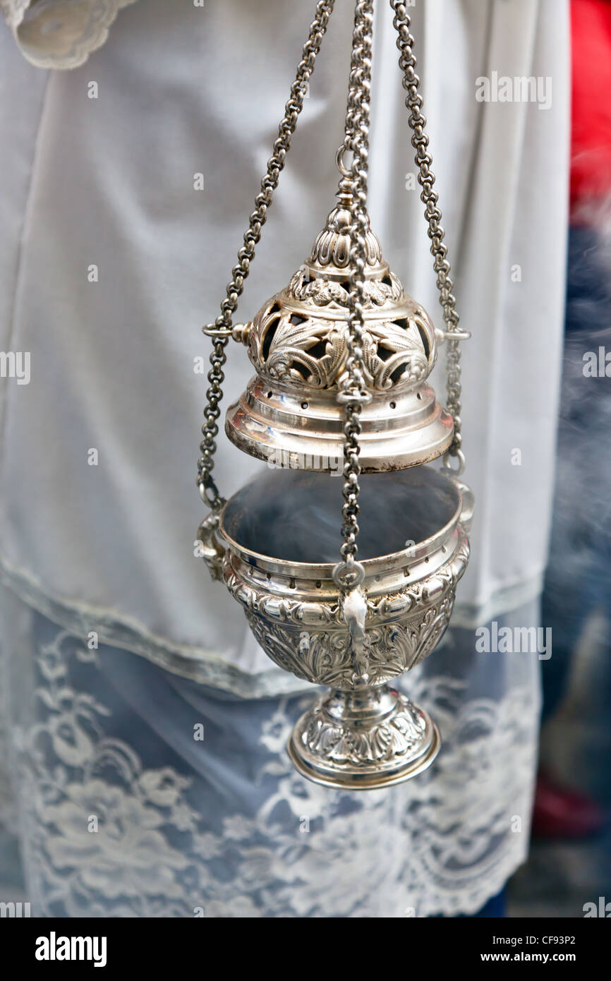 a jar full of incense in a religious procession. Stock Photo