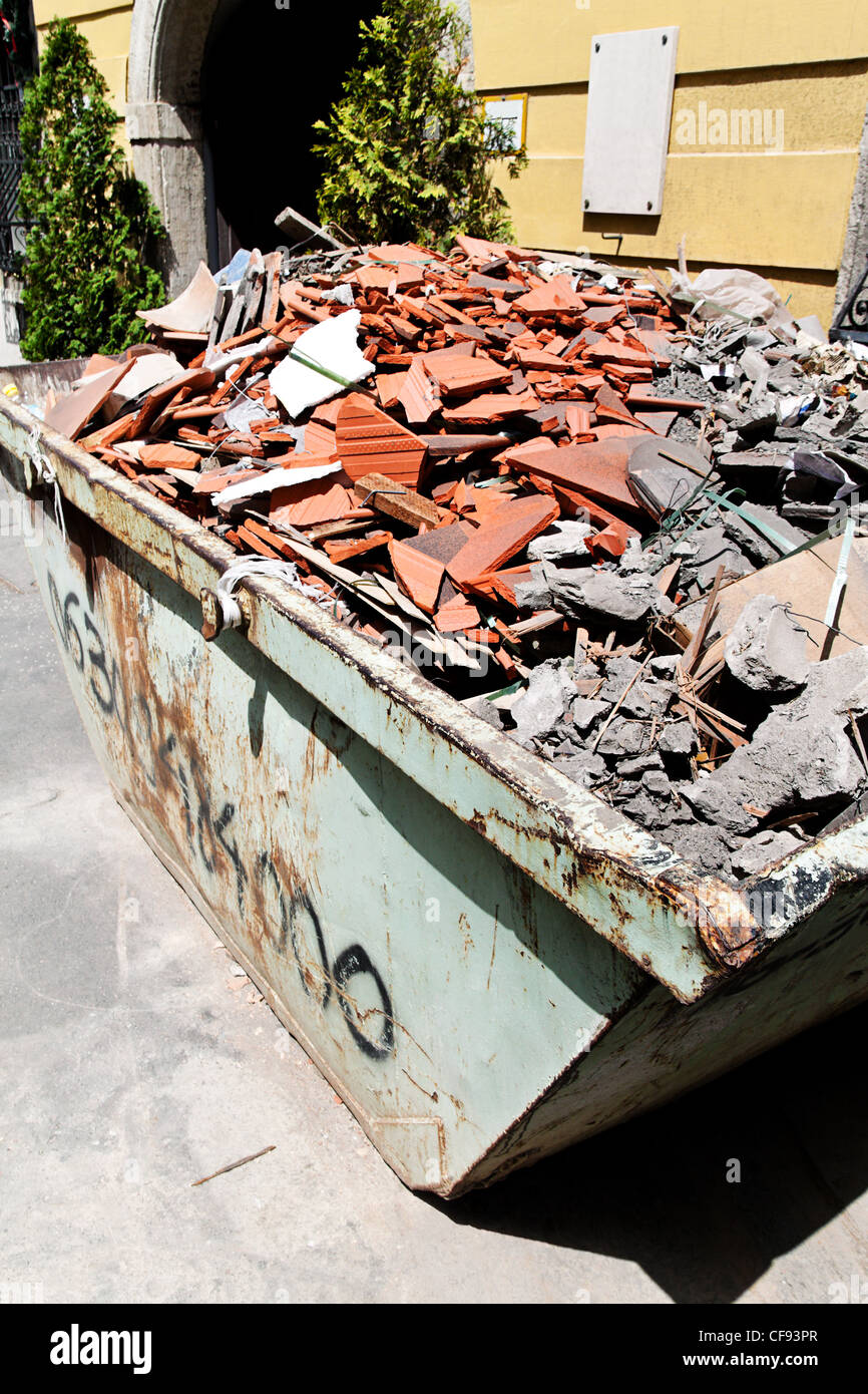 a container with construction debris at a construction site is waiting for his transport Stock Photo