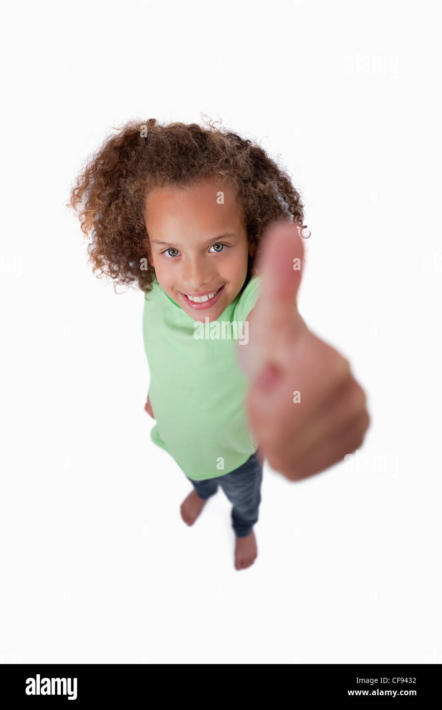Portrait of a smiling girl with the thumb up Stock Photo - Alamy