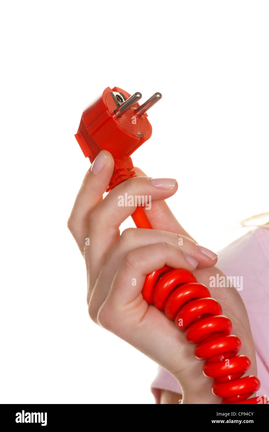 the hand of a woman holding a red power connector. Stock Photo