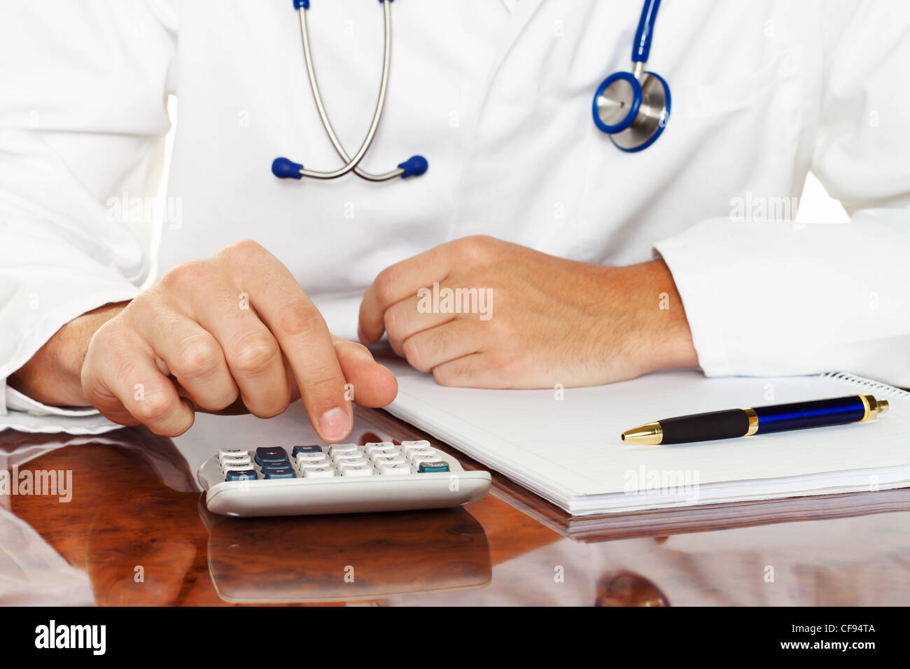 doctor with a calculator. calculation of costs and revenues in physician practice and hospital Stock Photo