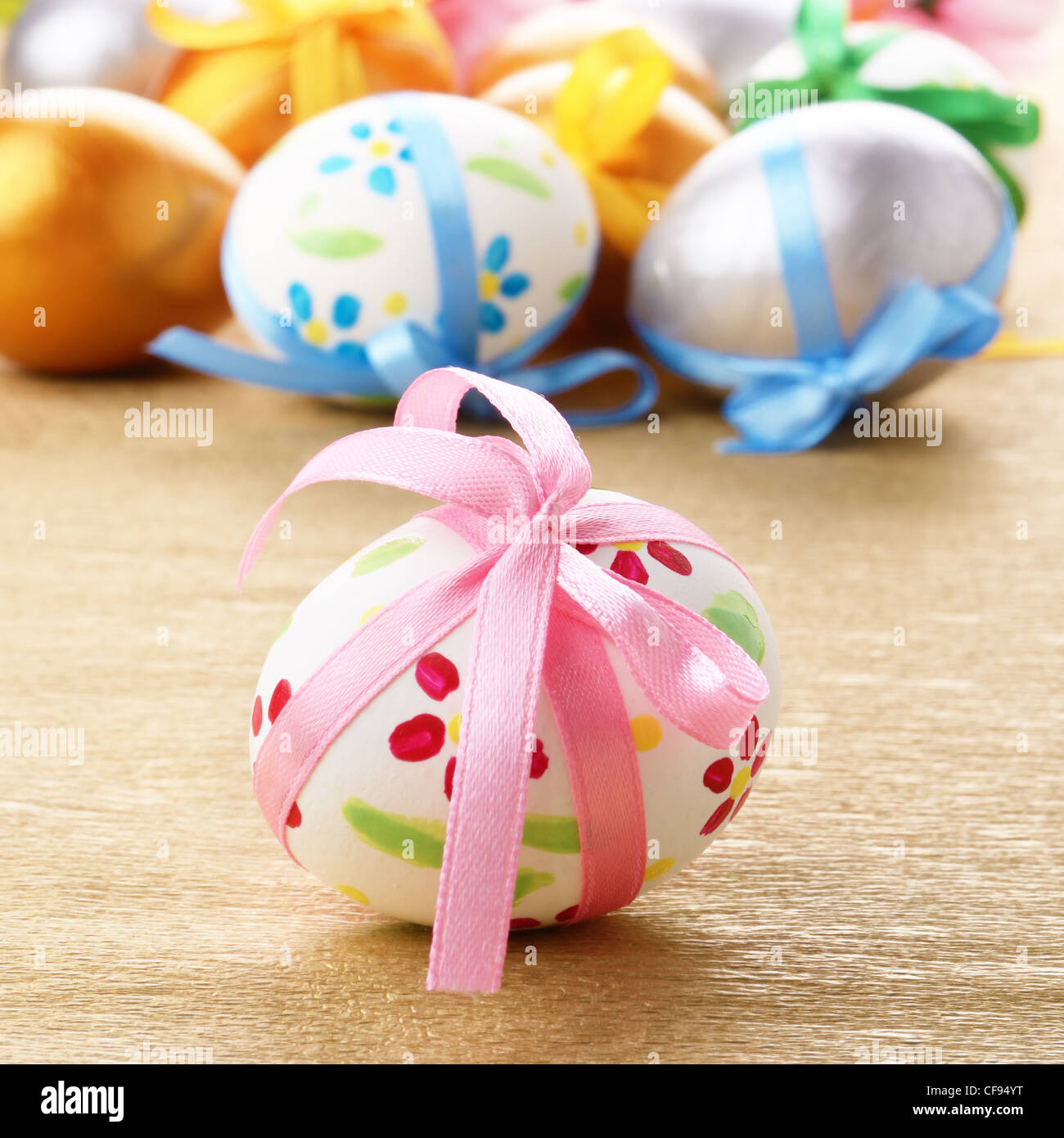 Easter eggs with bows on gold Stock Photo - Alamy