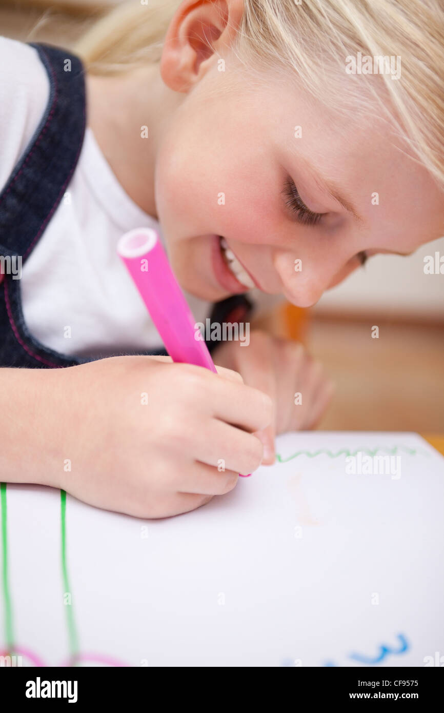 Portrait of a delighted girl drawing Stock Photo - Alamy