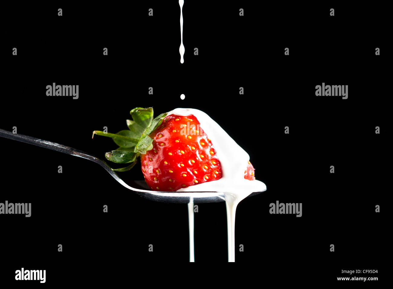 Picture of a black background with a strawberry and cream dripping over ...