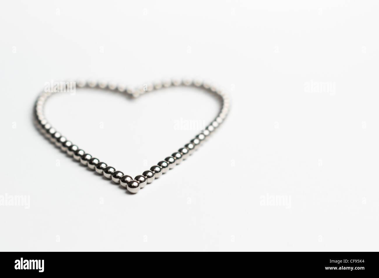 A picture of ball bearings in the shape of a heart Stock Photo