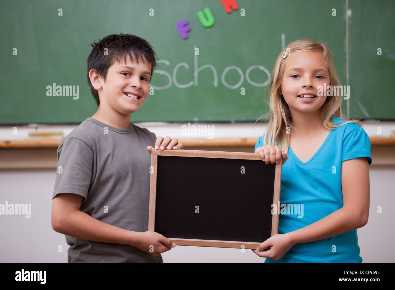 Pupils holding a school slate Stock Photo - Alamy