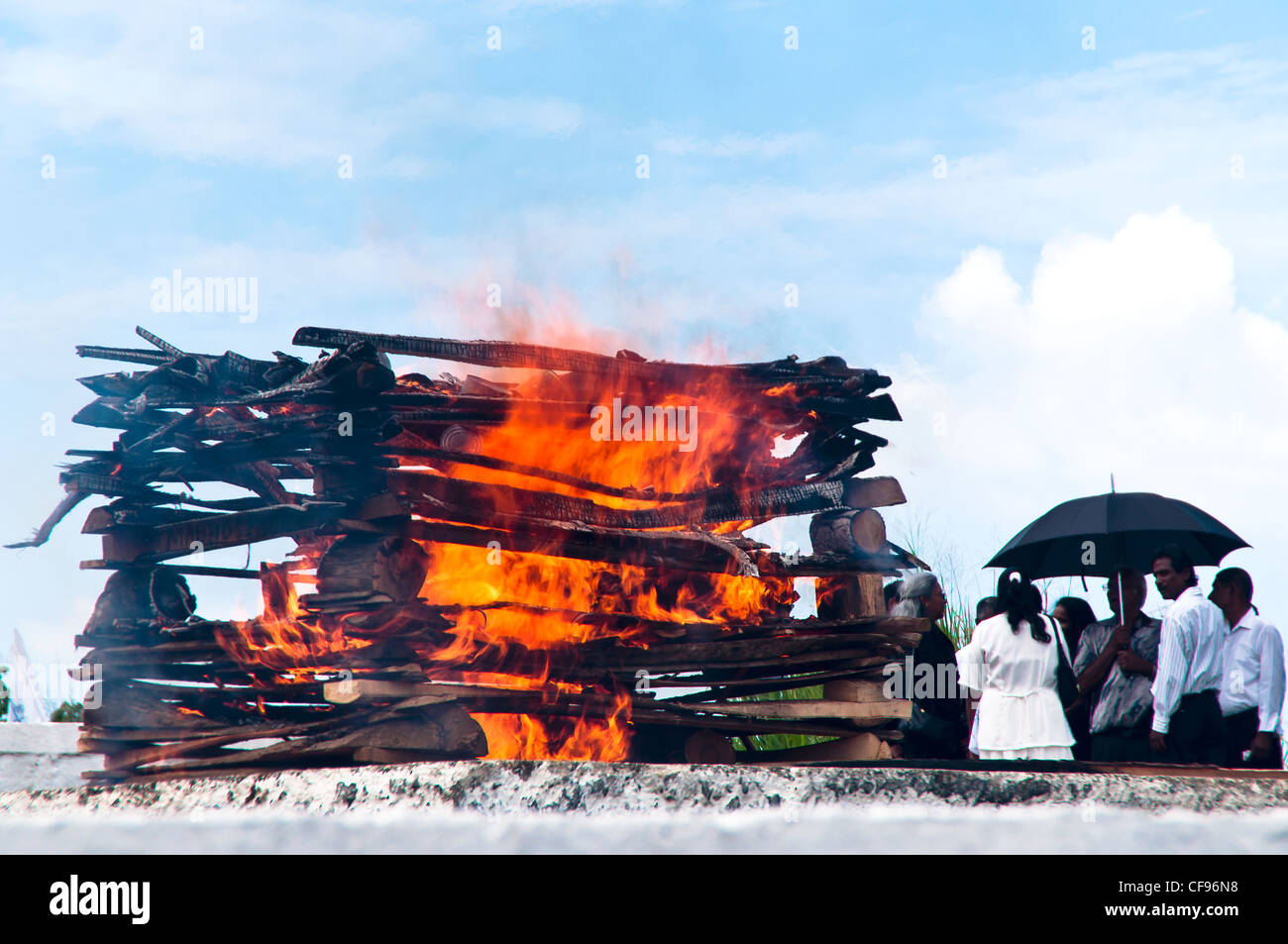 Hindu funeral rights of burning the body on a tall wooden funeral pyre sometimes take place on the beaches near San Fernando. Stock Photo