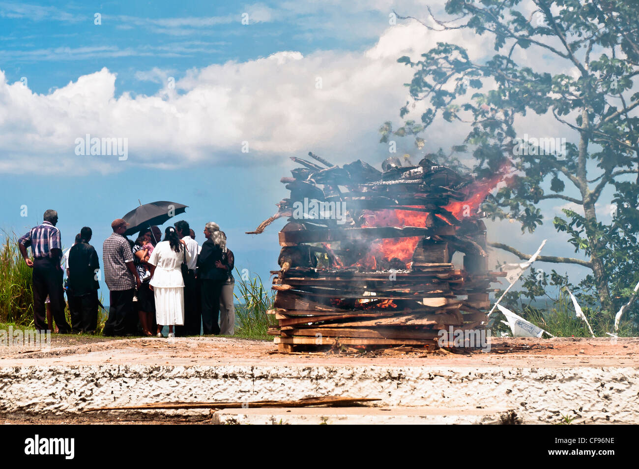 Hindu funeral rights of burning the body on a tall wooden funeral pyre sometimes take place on the beaches near San Fernando. Stock Photo