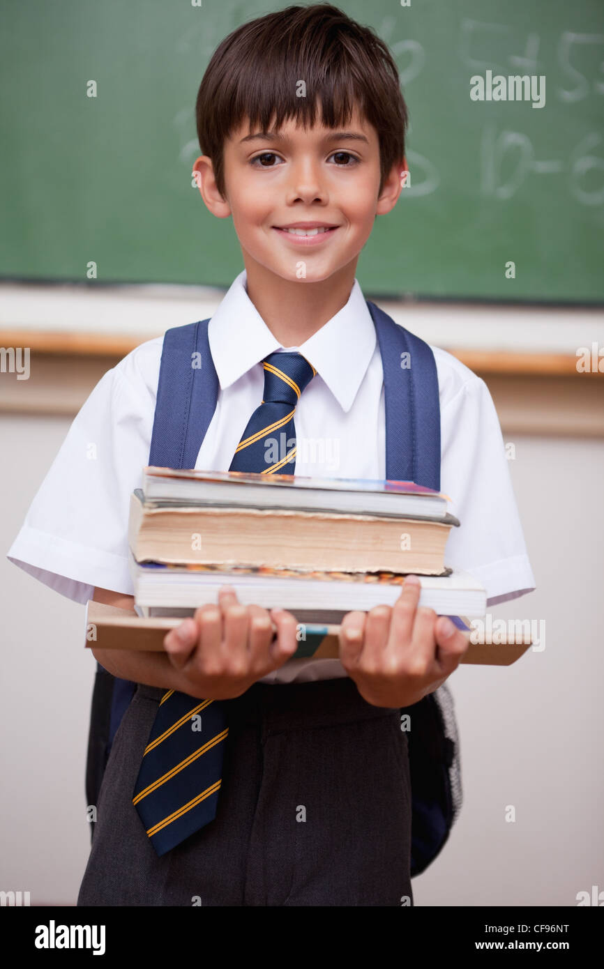 Portrait of a schoolboy holding books Stock Photo - Alamy