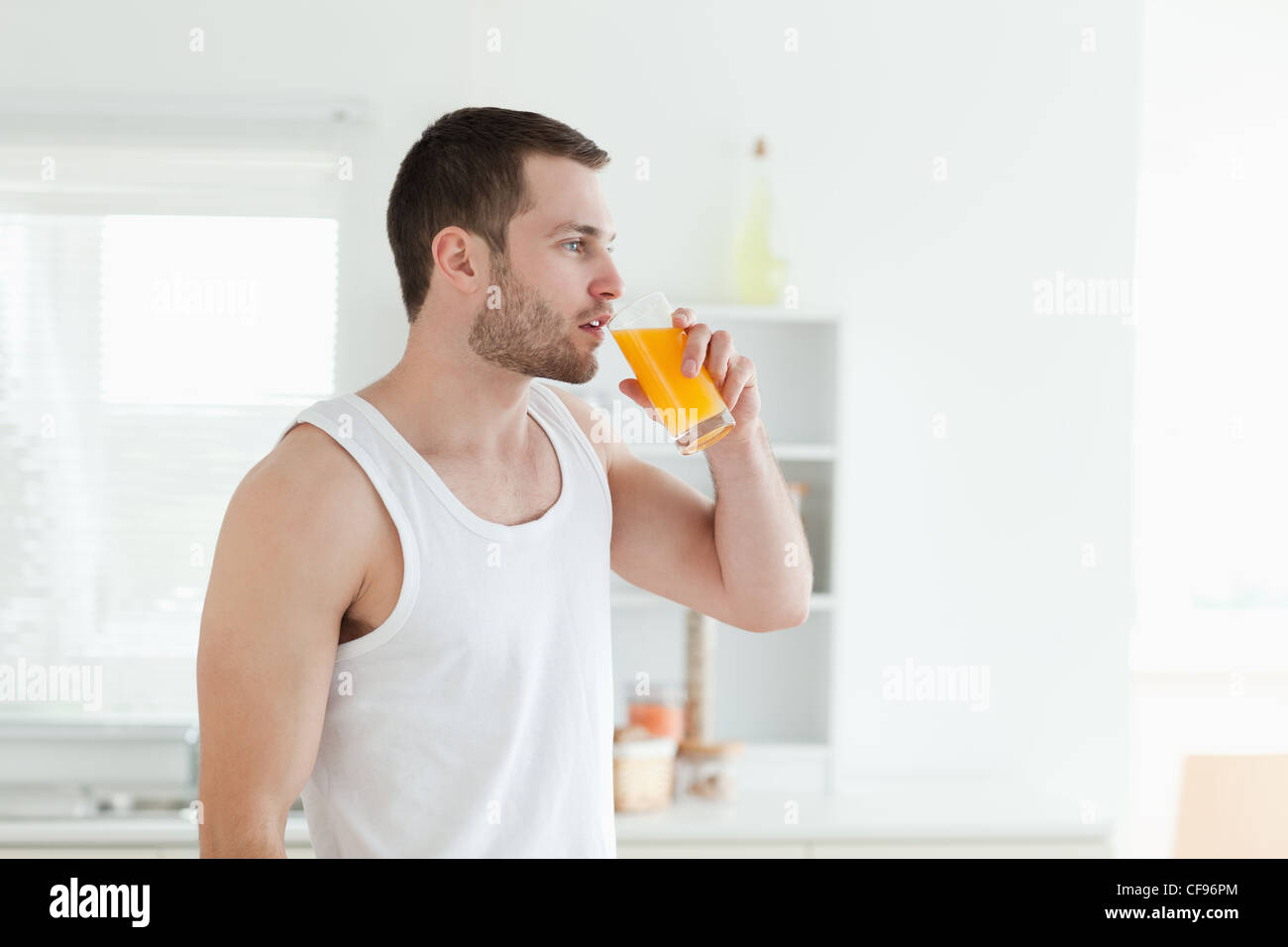 Quiet man drinking orange juice Stock Photo Alamy