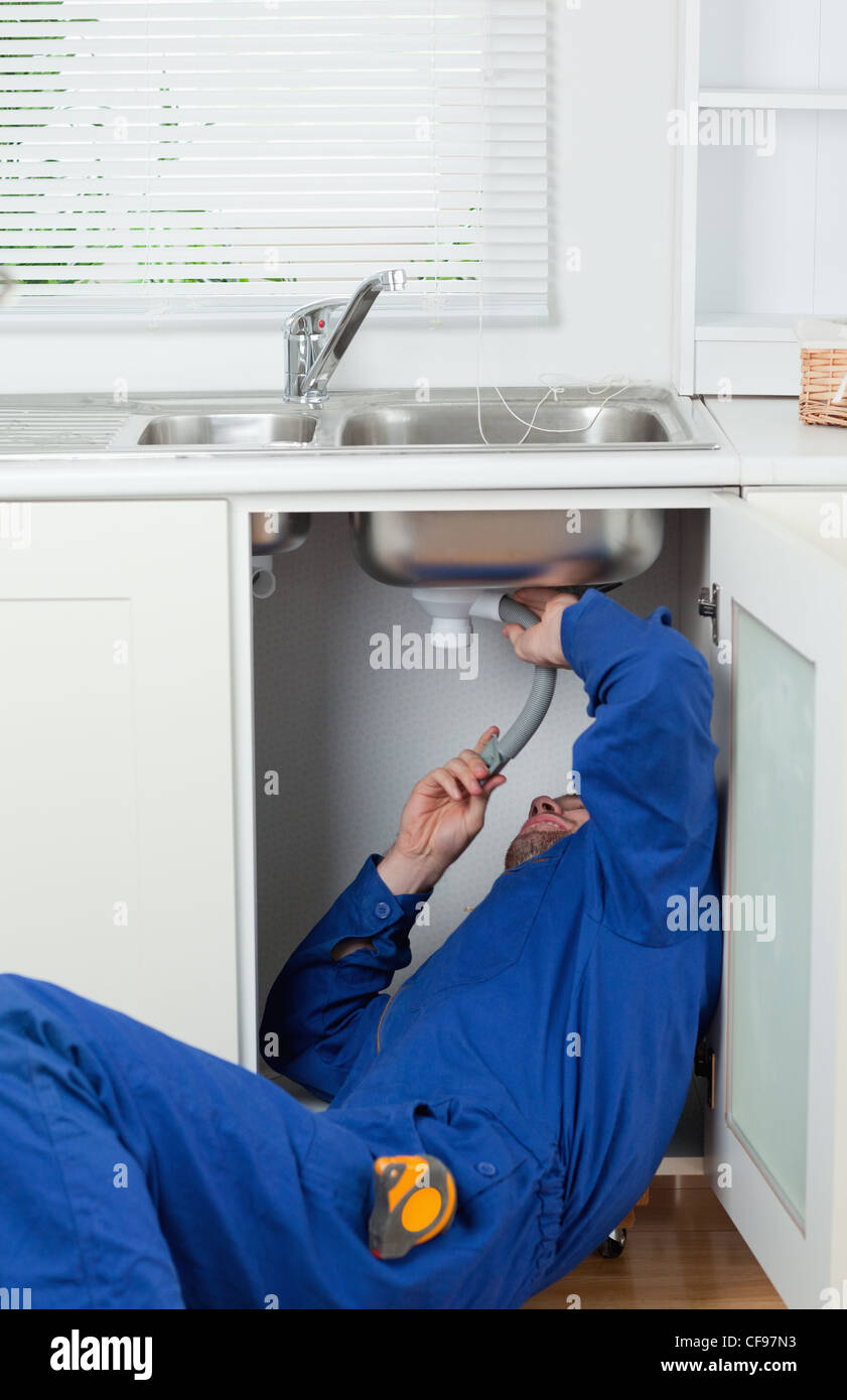 Portrait of a repairman fixing a sink Stock Photo Alamy