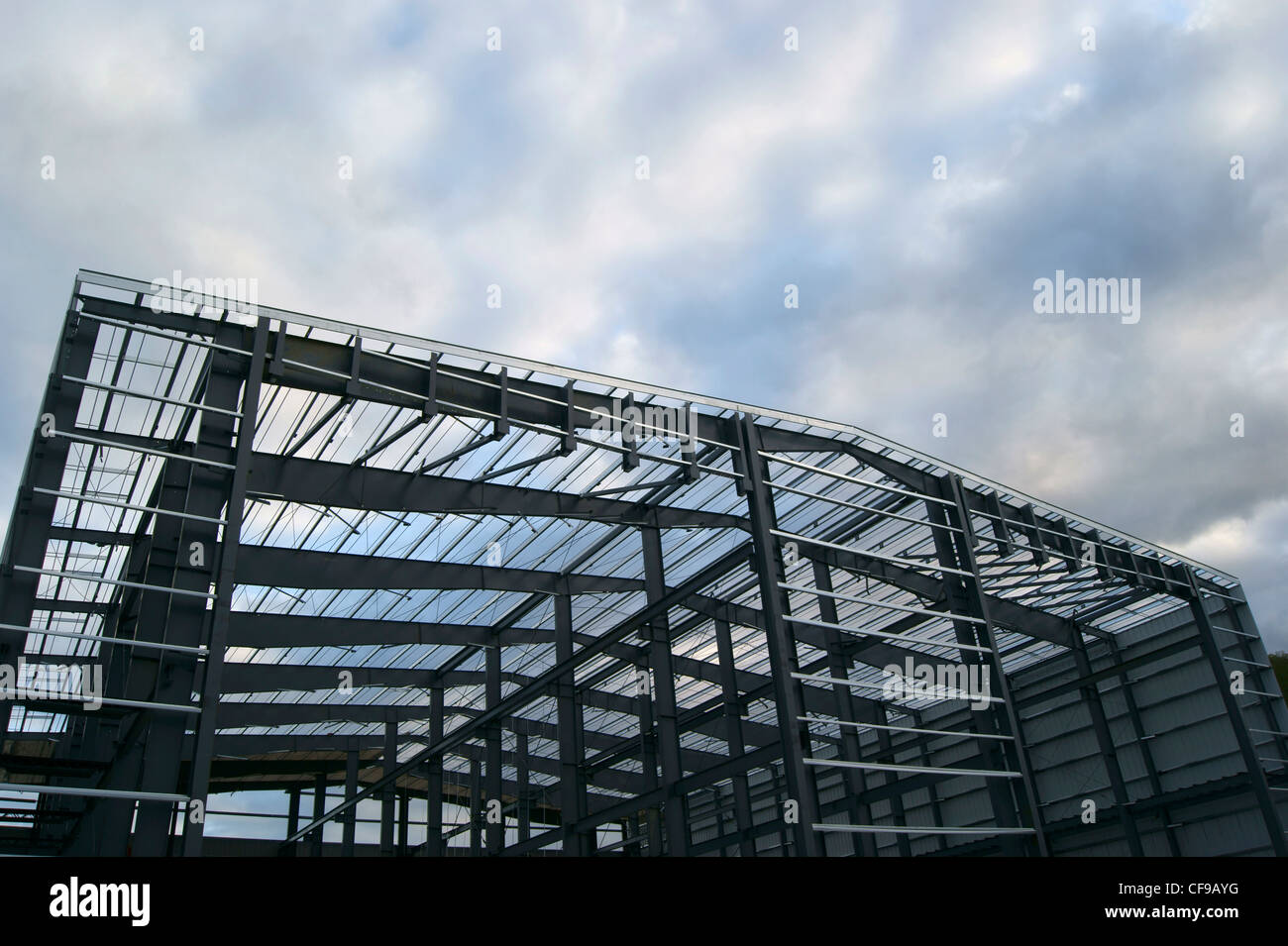 Low-angle view of steel girders in a building under construction with clouds in the background, Belfast, Maine. Stock Photo